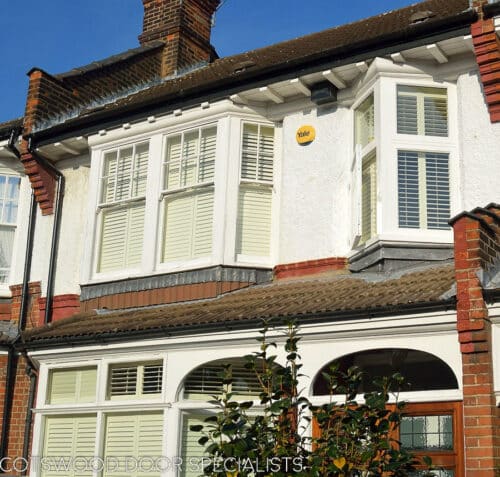 Oriel casement window. White wooden double glazed oriel window fitted into an Edwardian London home. Clear glass and white painted wood. Photo of house showing box sash windows too