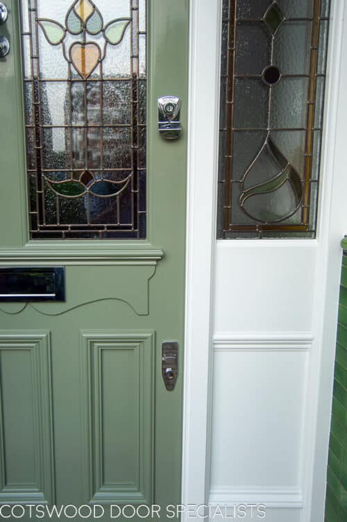 Green Edwardian front door. Ornate Edwardian front door with 5 glazed panels. Decorative dental block mouldings and also apron of which letterplate is fitted to. Glossy green paint with white door frame. Impressive front entrance with large apreture surrounded by decorative brick arch. Door frame has double sidelights. Full stained glass design to all galzing including the number above the door. Polished chrome door hardware